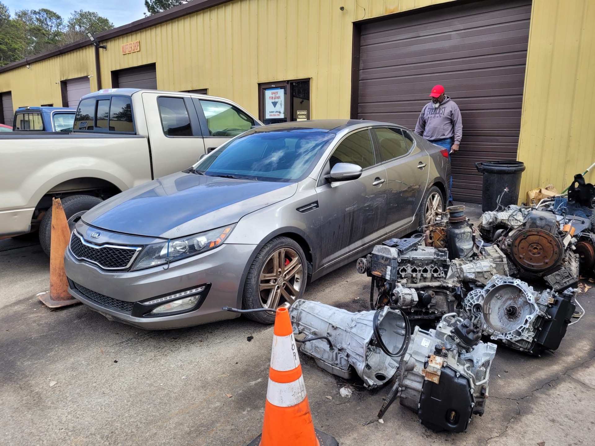 Cars and transmissions outside the Divine Transmission & Auto Care shop