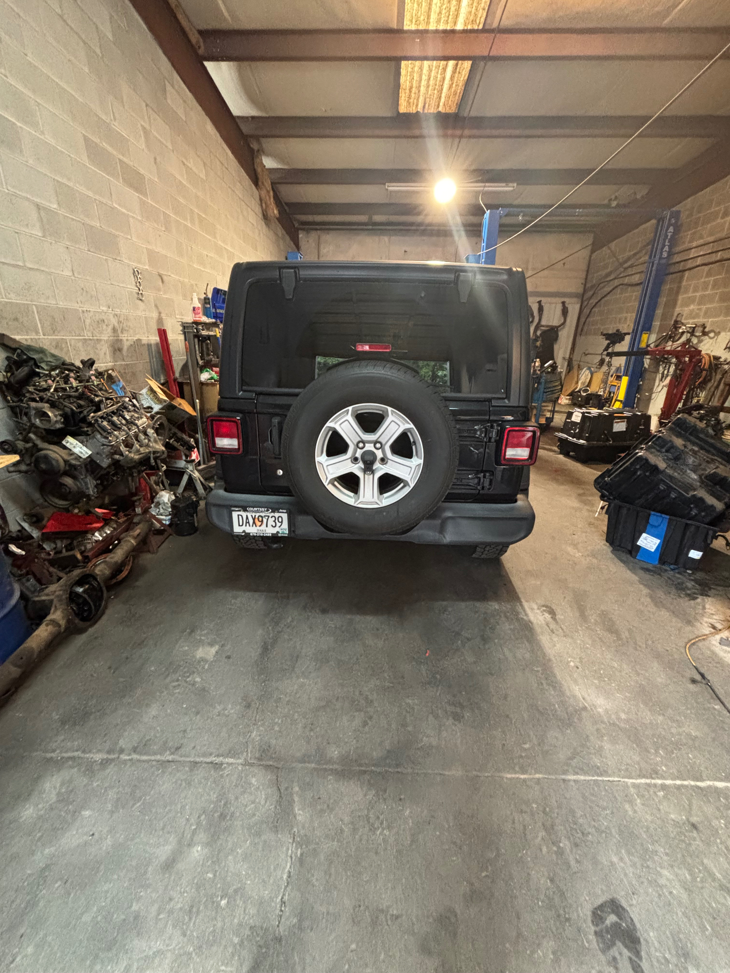 Vehicle on the lift inside the Divine Transmission service bay